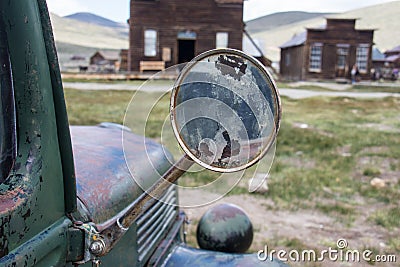 Focus on an old classic rearview mirror on a classic jalopy truck, abandoned in the Bodie Ghost Town in California Stock Photo