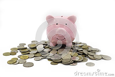 Focus of Pink piggy Bank on a pile of many coins isolated on white background. Stock Photo