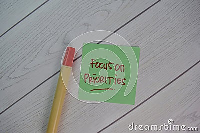 Focus on Priorities write on sticky notes isolated on Wooden Table Stock Photo