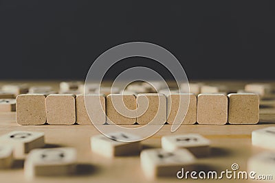 Focus of row made of eight empty cubes surrounded by blocks with letters isolated on black Stock Photo