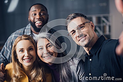 Focus of smiling multicultural colleagues looking Stock Photo