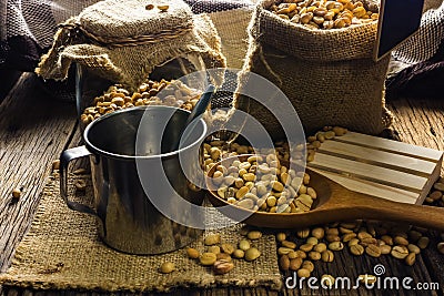 Focus Spot Coffee beans and coffee cup on a wooden table. Stock Photo