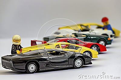 Focus-stacking with Lego figures next to a row of toy cars partly out of focus Editorial Stock Photo