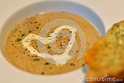 Focus view warm mushroom soup decorated with heart shaped cream Stock Photo