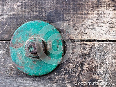 Focus of vintage green bolt on vintage wood Stock Photo