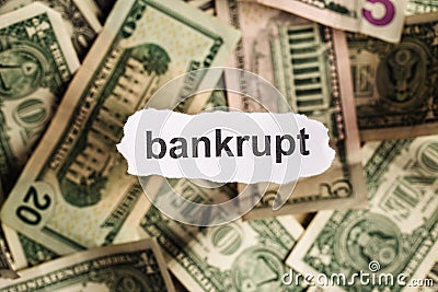Focus on the word BANKRUPT on piece of torn white paper with blu Stock Photo