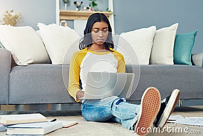 Focused on acing her finals. a young female student studying at home. Stock Photo