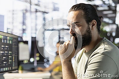 Focused admin thinking how to use cloud computing resources Stock Photo