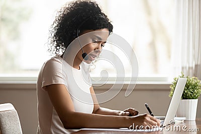 Focused african ethnicity lady watching educational online lecture webinar. Stock Photo