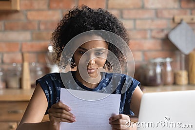 Focused Afro American student girl receiving important paper letter Stock Photo