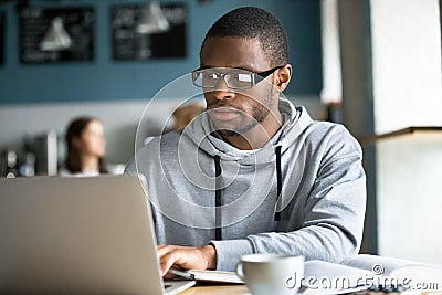 Focused black student studying online in coffeeshop Stock Photo