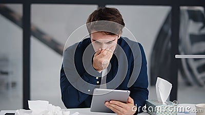 Focused business man reading pad in office. Ill man getting flu in office. Stock Photo