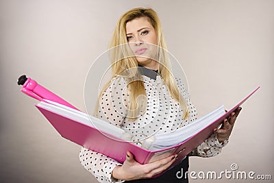Focused business woman holding binder with documents Stock Photo