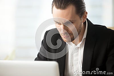 Focused businessman looking on laptop screen Stock Photo