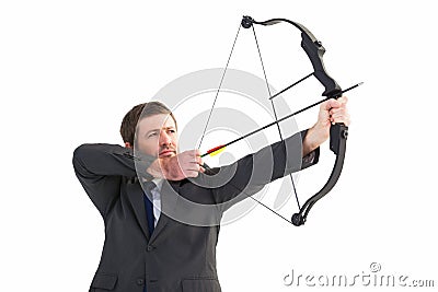 Focused businessman shooting a bow and arrow Stock Photo