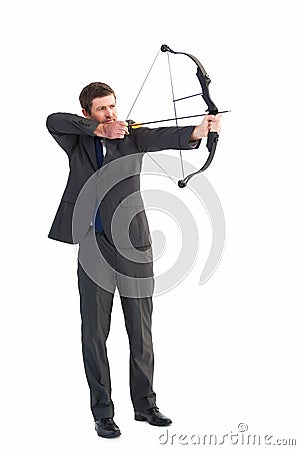 Focused businessman shooting a bow and arrow Stock Photo