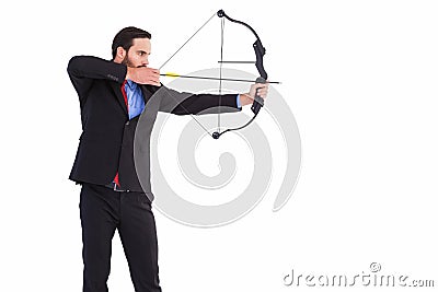 Focused businessman shooting a bow and arrow Stock Photo