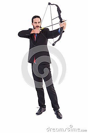 Focused businessman shooting a bow and arrow Stock Photo