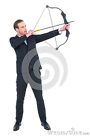 Focused businessman shooting a bow and arrow Stock Photo