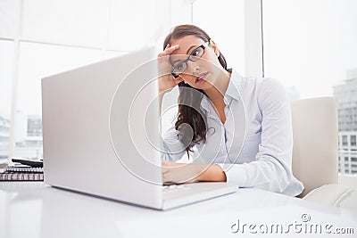 Focused businesswoman using laptop at desk Stock Photo