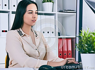 Focused businesswoman working at desk in creative office Stock Photo