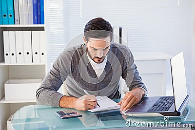 Focused casual businessman working at his desk Stock Photo