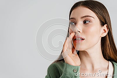 Focused caucasian girl whispering and looking aside Stock Photo