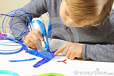 Focused child creating new 3d object with 3d printing pen Stock Photo
