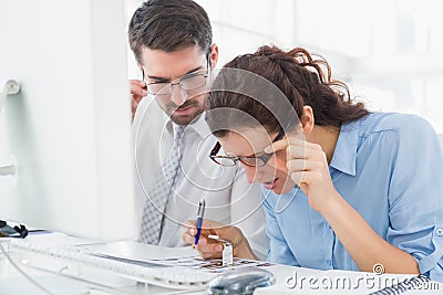 Focused coworkers looking photos together Stock Photo