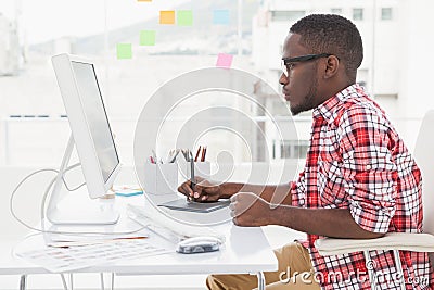 Focused designer using digitizer and computer Stock Photo