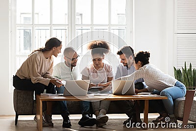 Focused diverse students working on research project together at home Stock Photo