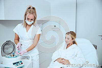 Focused doctor getting ready for a platelet-rich plasma injection Stock Photo