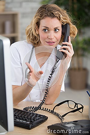 Focused doctor talking on phone Stock Photo