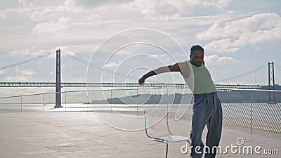 Focused man dancing ocean view closeup. African american dancer moving body Stock Photo