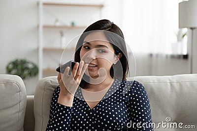 Millennial asian female use voice dialing function of modern smartphone Stock Photo