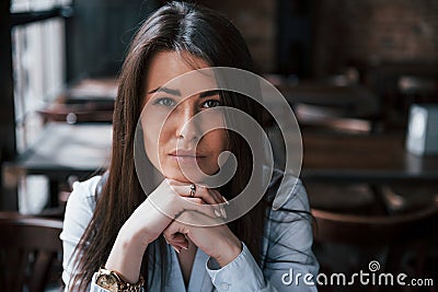 Focused photo. Businesswoman in official clothes is indoors in cafe at daytime Stock Photo