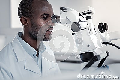 Focused photo of pleased dentist that working in clinic Stock Photo