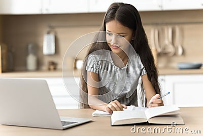 Focused positive schoolkid studying at home, watching online lesson Stock Photo