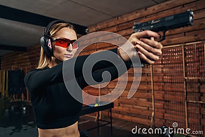 Focused pretty lady aiming at a target Stock Photo