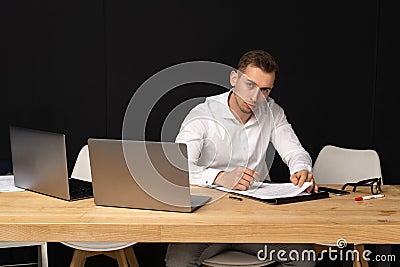 Focused serios businessman thinking of online task Stock Photo