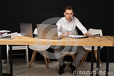 Focused serios businessman thinking of online task Stock Photo