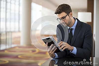 Focused Smart Young Businessman on Tablet Stock Photo