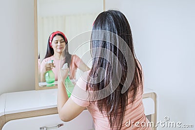 Focused view of beautiful woman cleaning a dresser Stock Photo