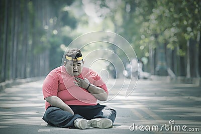 Focused view of fat Asian man patting his chest Stock Photo