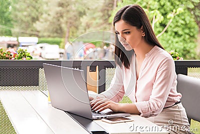 Focused at work. concentrated beautiful young businesswoman or student working on laptop Stock Photo