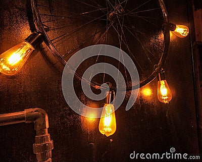 focused yellow light glass bulb and gradient light and cycle tire as a fixture Stock Photo