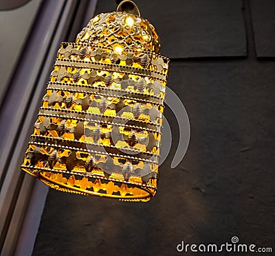 focused yellow light glass bulb with ornamented fixture and gradient light Stock Photo