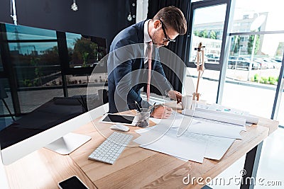 focused young businessman in eyeglasses working with papers Stock Photo