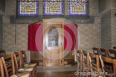 Focusing a wood confessional in a Catholic church Editorial Stock Photo