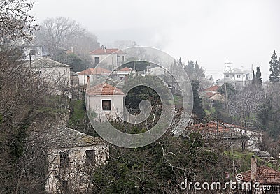 Fog above traditional houses in Milies village on mountain Pelion.Greece. Stock Photo